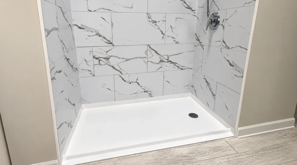 Roll-in shower with a flush entry and white marble tile for wheelchair access